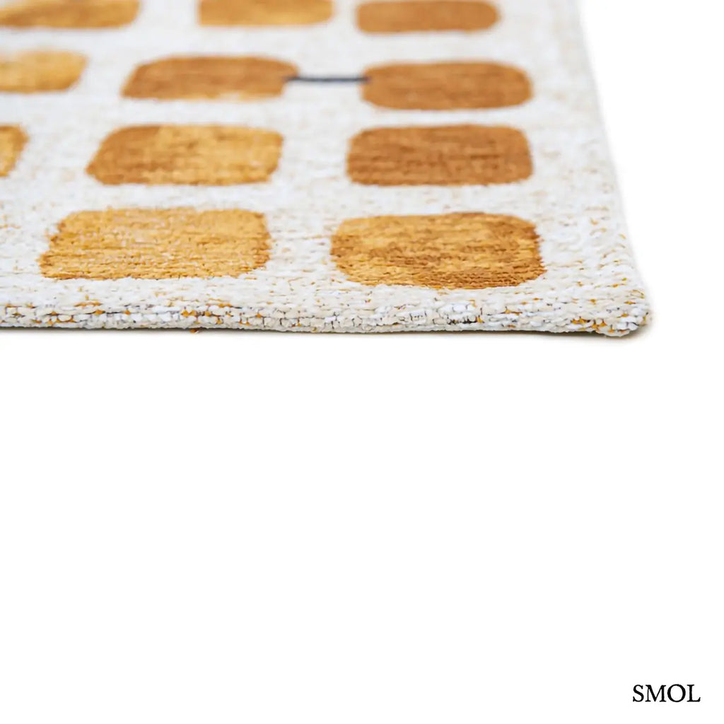 ECO RUG PEACH PARTY geometrikus szőnyeg arany-krém kombinációban, kerekített négyzetes mintával, fekete akcentusokkal, sarok nagyítva
