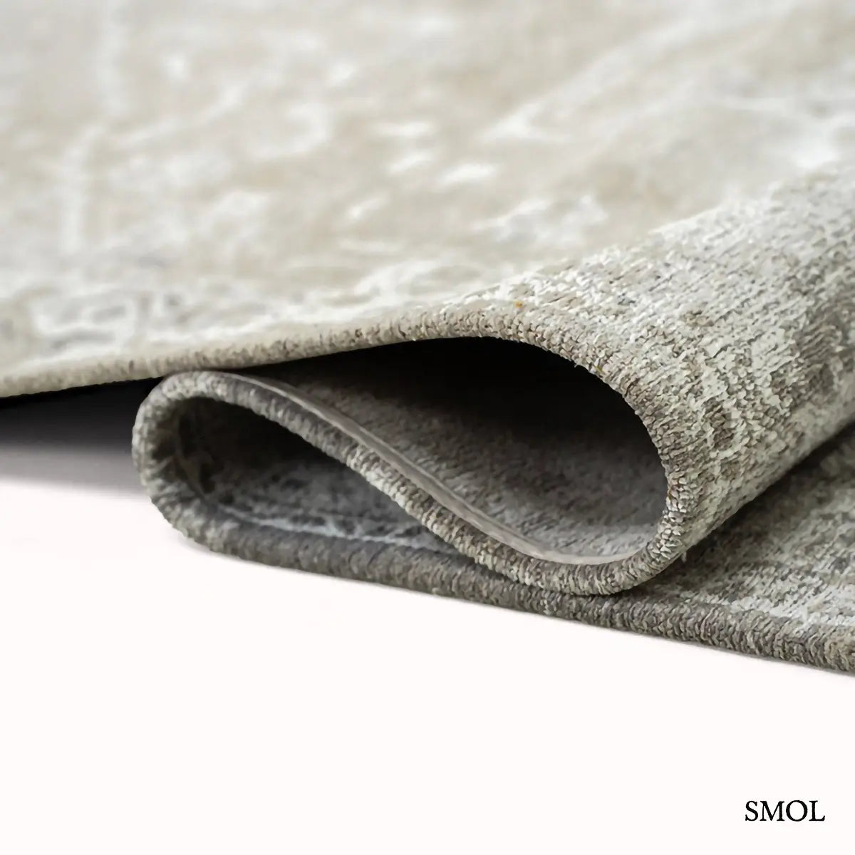 ECO RUG SUEDE perzsa mintás szőnyeg szürke-taupe tónusokban, koptatott felülettel, újrahasznosított poliészter, hullámosra hajtogatva