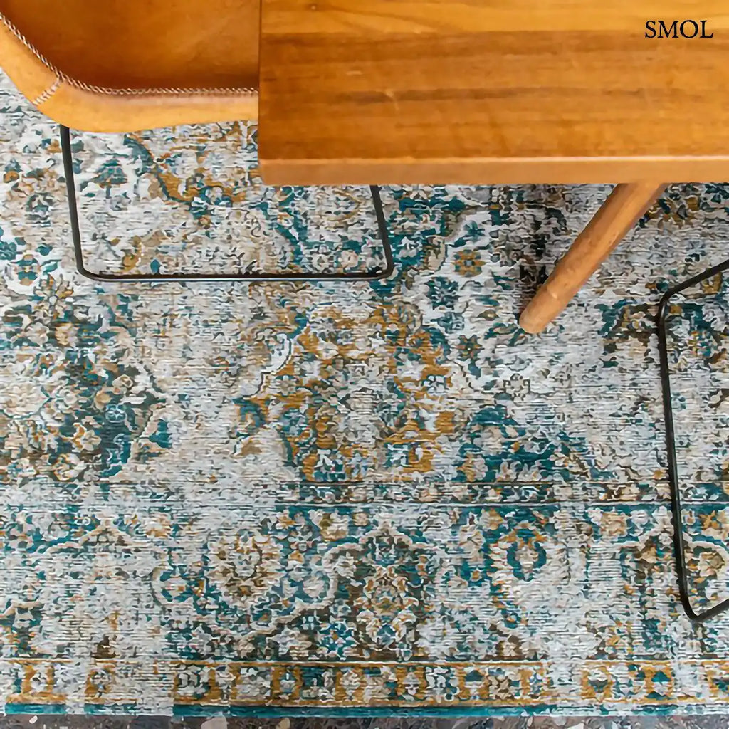 ECO RUG FENER virágos perzsa mintás szőnyeg mustár-türkiz kombinációban, koptatott Bakhtiari motívumokkal, asztal alatt