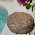 Kézzel fonott, natúr tengerifű puff (ülőke), kerek formájú, vastag fonással medence mellett