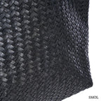 Fekete fonott bőr válltáska és óriás pakolós táska elegáns, kézzel készített textúrával, nagyítva oldalról