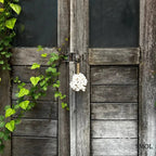 Kagylós táskadísz és kulcstartó fehér tengeri kagylókból, kézzel fonott tengerifűvel, ajtón