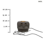 Kézzel faragott fekete kő mécsestartó misztikus arc szobor formában, sárgaréz betéttel, méretarányosan