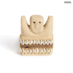 Kézzel faragott Sumba kőszobor homokkőből, fehér cowrie kagyló díszítéssel és rusztikus kötéllel, szemből