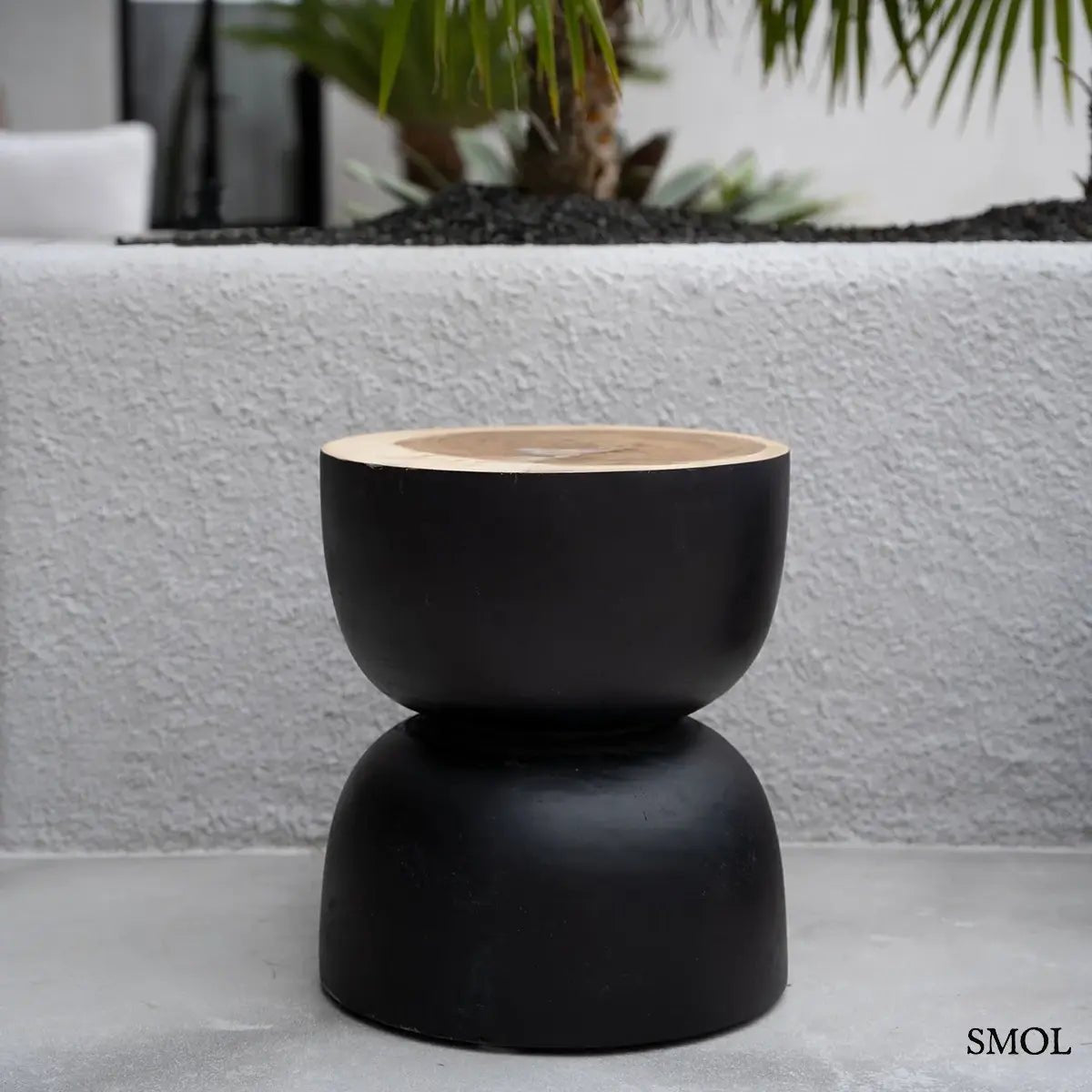 Kézzel faragott fekete suar fa lerakóasztal és ülőke organikus homokóra formában, teraszon