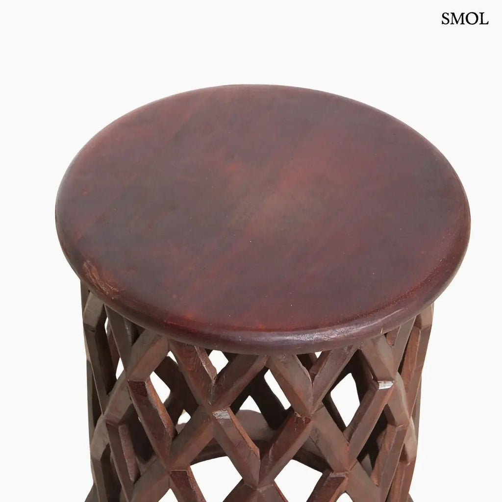 Sötét tónusú, kézzel faragott mangófa lerakóasztal és ülőke áttört rombusz mintázattal és sima, kerek fedőlappal, felülről