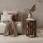 Fekete márványlapos lerakóasztal antik barna mangófa vázzal, henger alakú kisasztal modern és japandi stílusban, kanapé mellett, könyvekkel és vázával