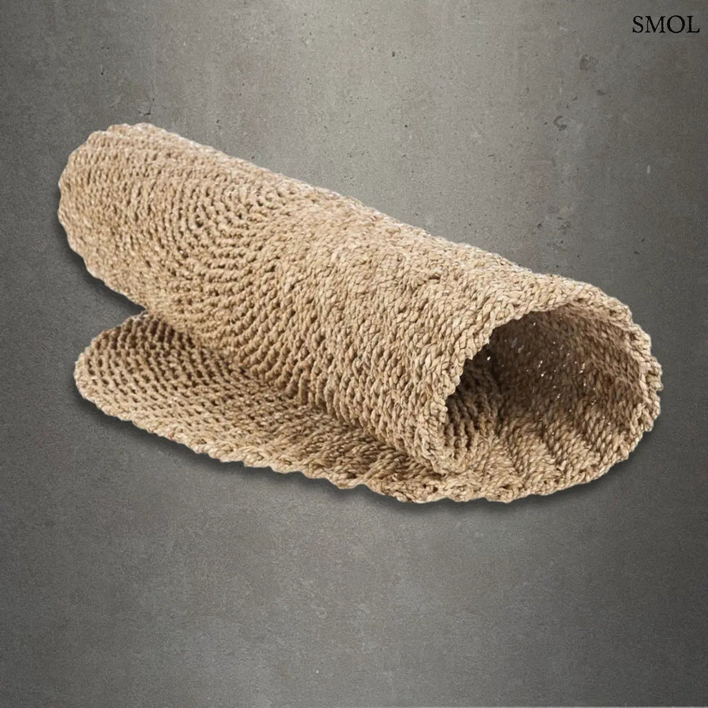 Természetes szizál szőnyeg kerek formában, kézzel font textúrával, homokszínű boho stílusban, szürke háttérrel