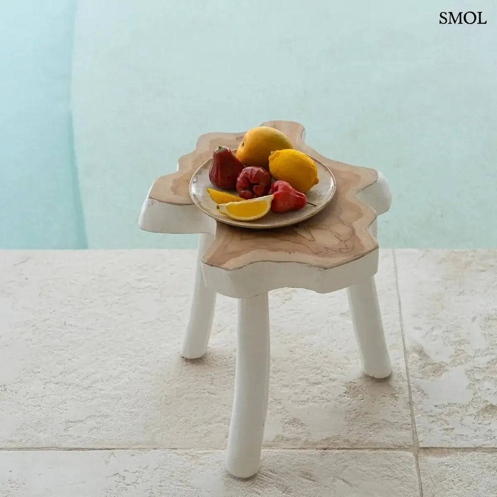 Háromlábú organikus teakfa lerakóasztal natúr fa tetővel és fehér lábakkal, bohém stílusban, gyümölcsökkel