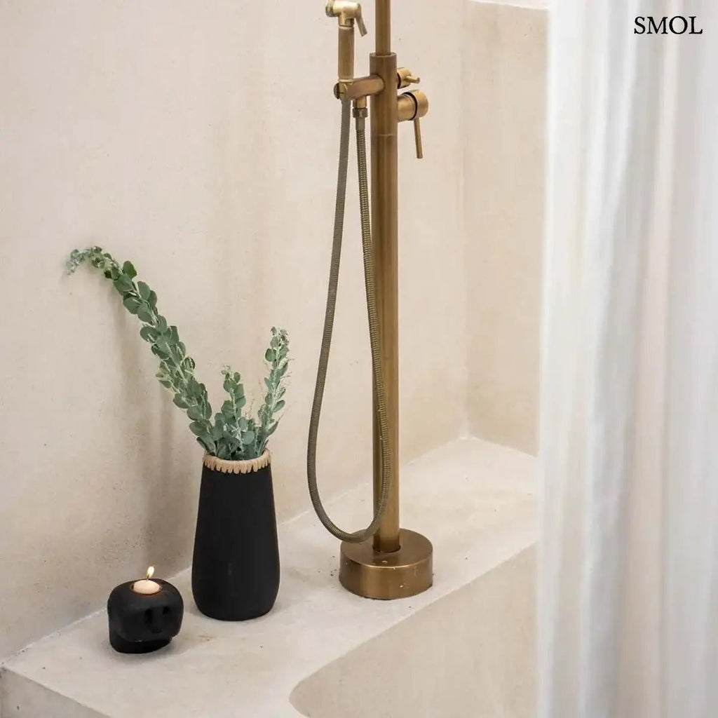 Fekete-natúr terrakotta váza felső részén fonott raffia díszítéssel, kézműves indonéz kerámia dekoráció, fürdőszobában, mécsestartóval