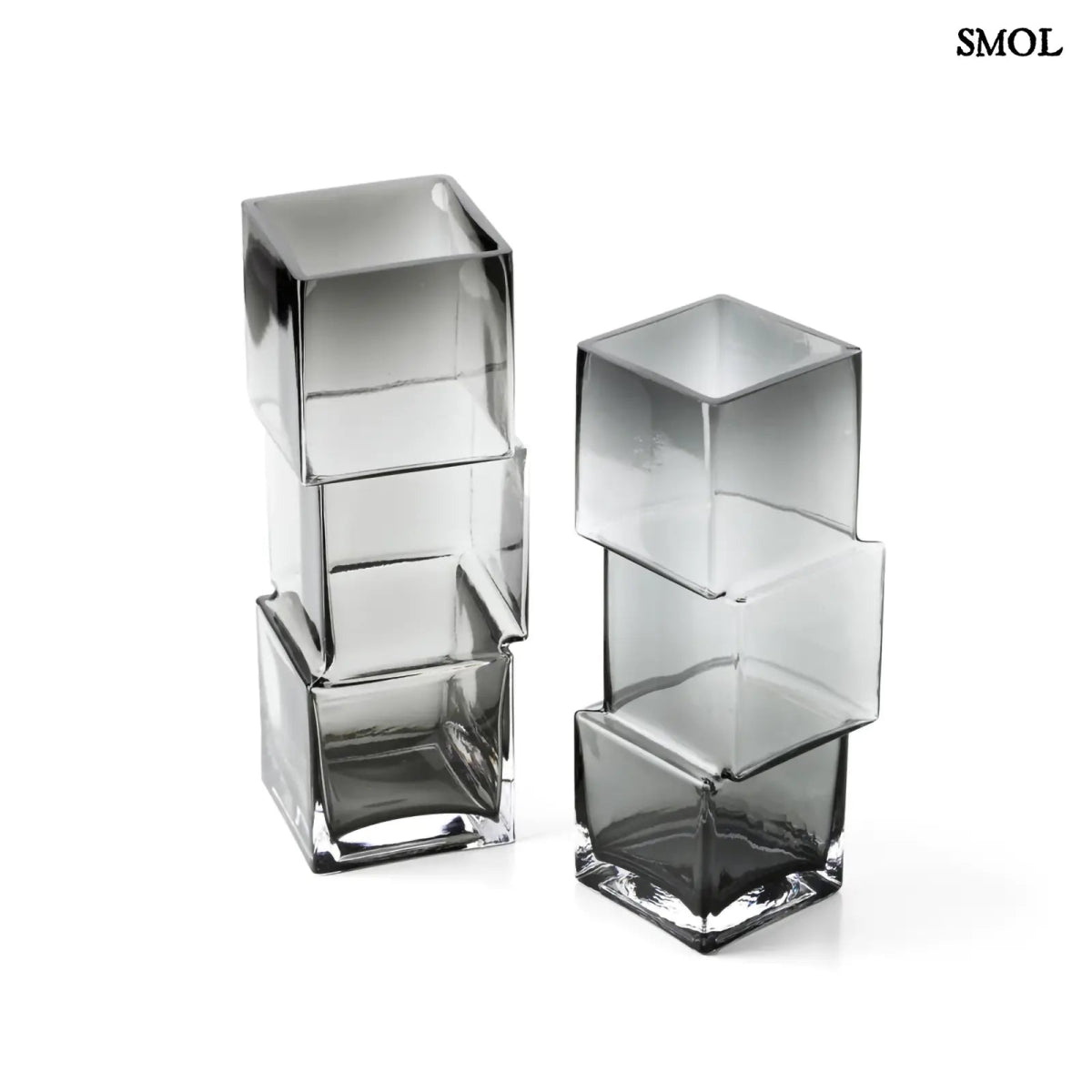 Függőlegesen elrendezett, három kocka alakú sötétszürke üveg váza, felülről
